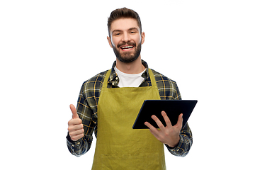 Image showing happy male gardener or farmer with tablet pc