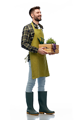 Image showing happy gardener or farmer with box of garden tools