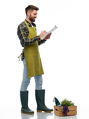 Image showing happy gardener with clipboard with garden tools