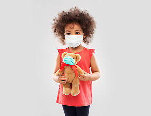 Image showing little african american girl in mask with teddy