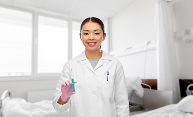 Image showing asian female doctor with syringe at hospital