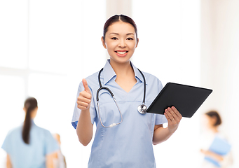 Image showing nurse with tablet pc shows thumbs up at hospital