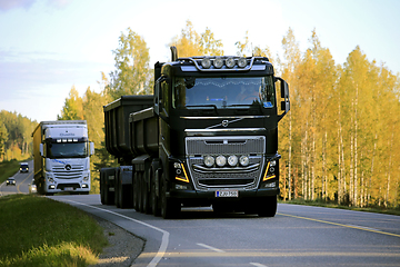 Image showing Heavy Trucks on Road at Autumn Sunset