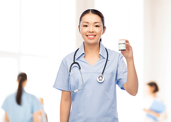 Image showing happy asian female nurse with medicine at hospital