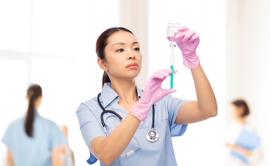 Image showing asian female nurse with medicine and syringe