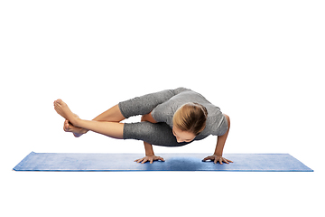 Image showing woman making yoga in handstand on mat