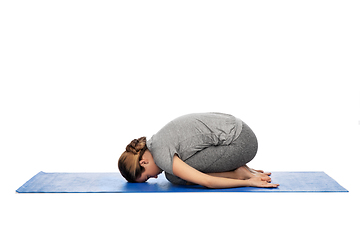 Image showing woman doing yoga child pose on mat