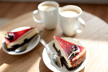 Image showing pieces of chocolate cake on wooden table