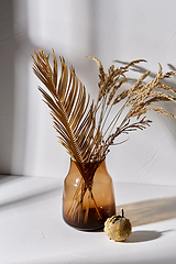 Image showing decorative dried flowers in glass vase and pumpkin