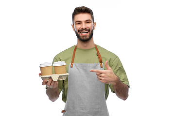 Image showing happy smiling barman in apron with takeaway coffee