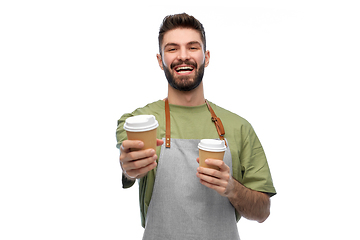 Image showing happy smiling barman in apron with takeaway coffee