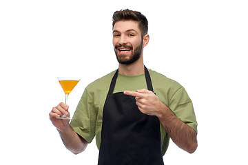 Image showing happy barman in apron with glass of cocktail