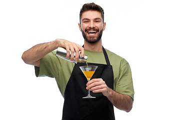 Image showing happy barman with shaker and glass preparing drink