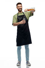 Image showing barman with bottle and shaker preparing drink