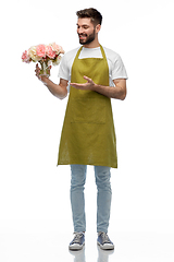 Image showing happy smiling male gardener with flowers in vase