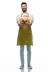 Image showing happy smiling male gardener with flowers in vase