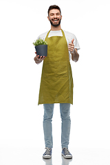 Image showing happy male gardener with flower showing thumbs up