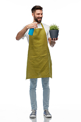 Image showing happy smiling male gardener moisturizing flower