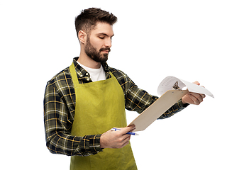 Image showing male gardener with clipboard and papers