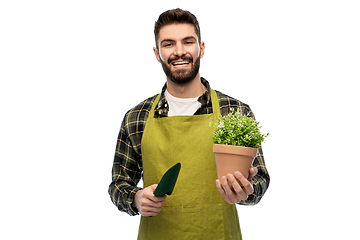Image showing happy gardener or farmer with trowel and flower