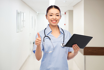 Image showing nurse with tablet pc shows thumbs up at hospital