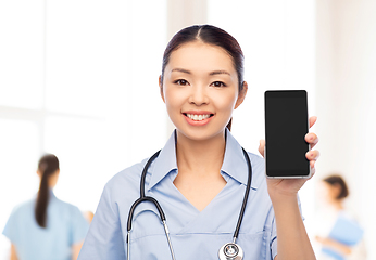 Image showing asian female nurse with smartphone at hospital