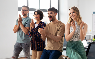 Image showing happy business team applauding at office