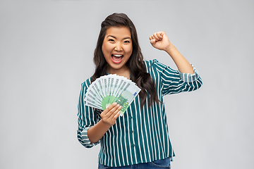 Image showing happy asian woman with money celebrating success