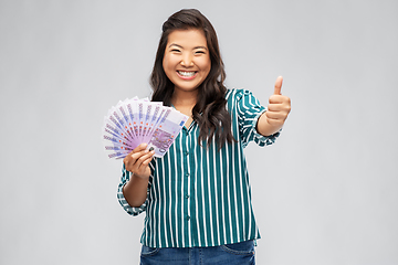 Image showing asian woman with euro money showing thumbs up