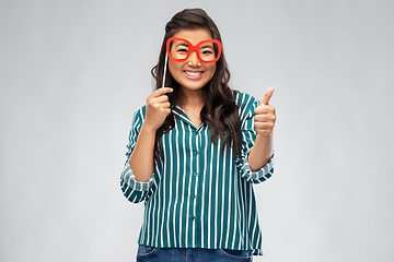 Image showing asian woman with party glasses showing thumbs up