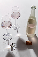 Image showing wine glasses and champagne bottle dropping shadows