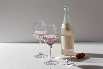 Image showing wine glasses and champagne bottle dropping shadows