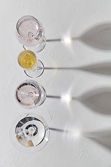 Image showing wine glasses dropping shadows on white surface