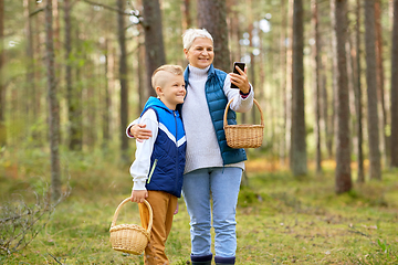 Image showing grandmother and grandson with baskets take selfie