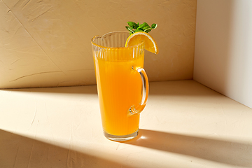 Image showing jug with orange juice and peppermint on table
