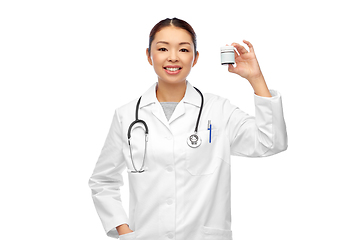 Image showing smiling asian female doctor or nurse with medicine