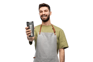 Image showing happy waiter with tumbler or takeaway thermo cup