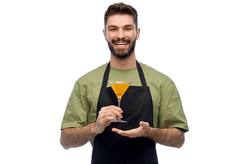 Image showing happy barman in apron with glass of cocktail