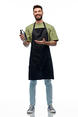Image showing happy barman in apron with shaker
