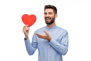 Image showing happy smiling young man with red heart