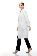 Image showing smiling female doctor or scientist walking