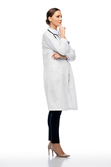 Image showing thinking female doctor in white coat