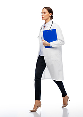 Image showing female doctor walking with clipboard