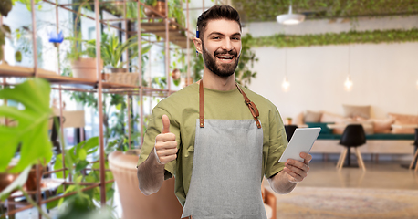 Image showing waiter with notepad shows thumbs up at restaurant