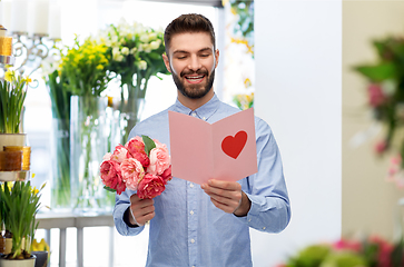 Image showing happy man with valentine's day card at flower shop