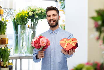 Image showing happy man with valentine's day gift at flower shop