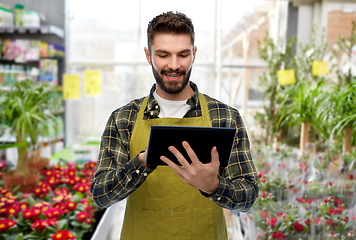 Image showing gardener or seller with tablet pc at flower shop