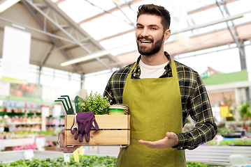 Image showing gardener with box of tools at flower shop