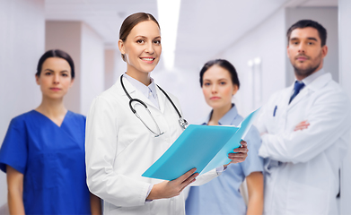 Image showing smiling female doctor with colleagues at hospital