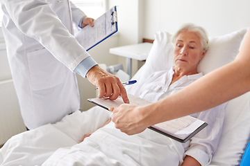 Image showing senior woman and doctors at hospital